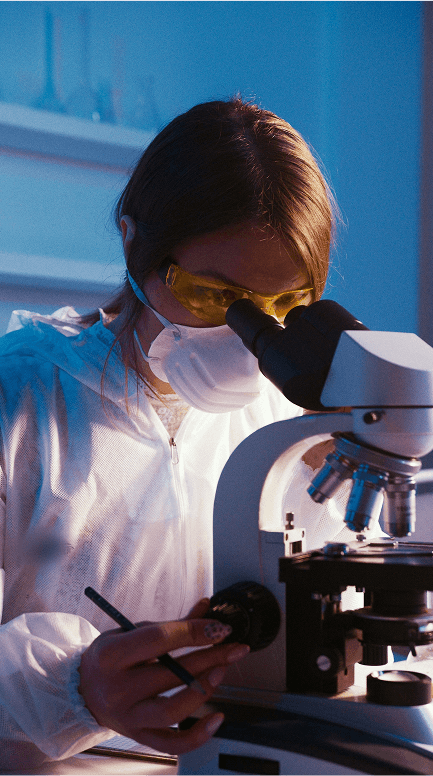 A person looking down a microscope