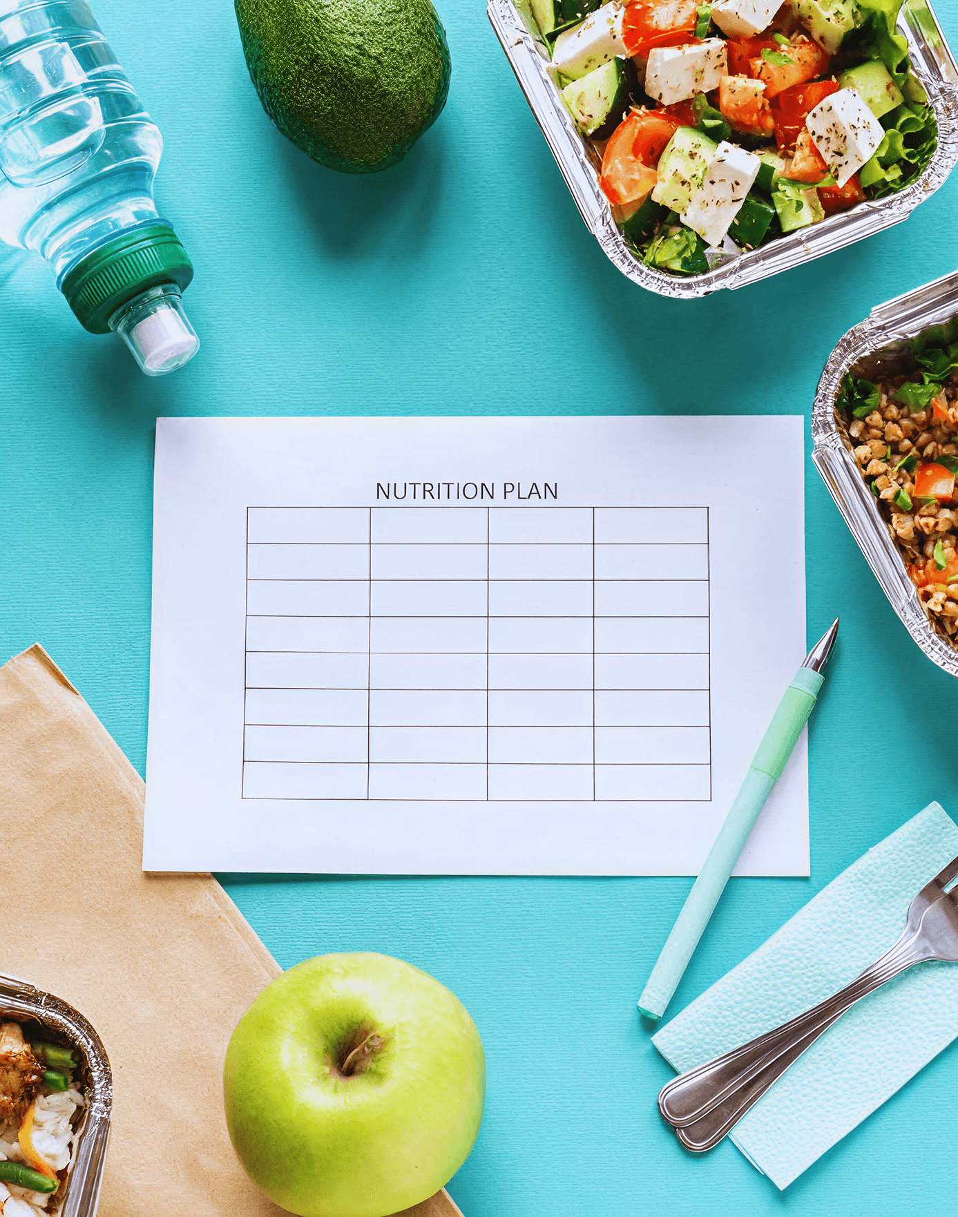 A blank sheet with a Nutrition Plan table on it, surrounded by various fruits and vegetables