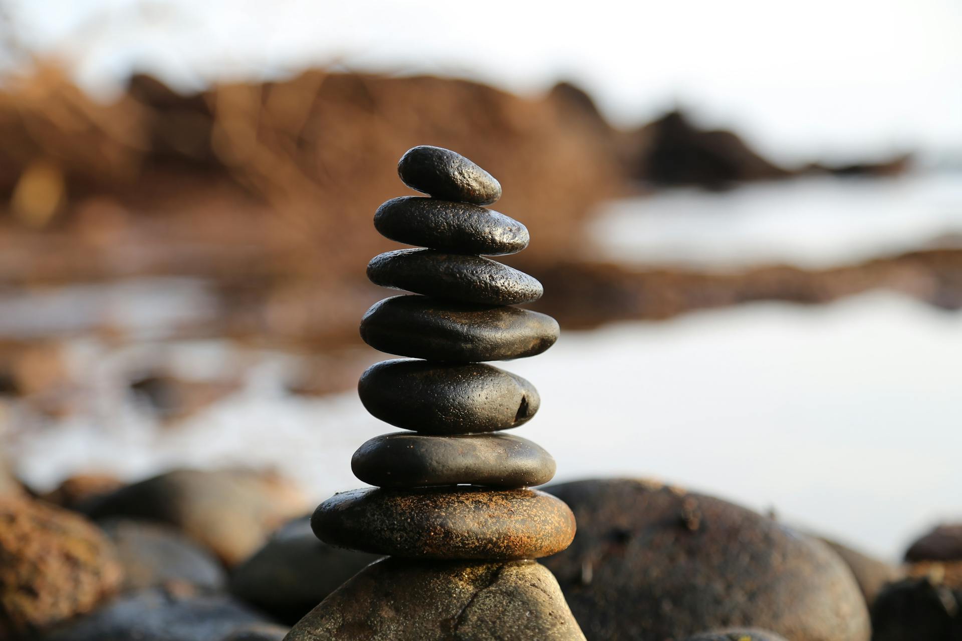 A stack of rocks next to the ocean